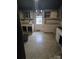 Outdated kitchen features white cabinets, countertops, and neutral tile flooring awaiting a buyer's creative ideas at 50 Ranlo Ave, Gastonia, NC 28054