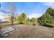 Large backyard with grassy area and small patio at 11131 Cypress View Dr, Charlotte, NC 28262