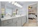 Main bathroom with double sinks and a view of bedroom at 11131 Cypress View Dr, Charlotte, NC 28262