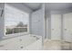 Main bath with soaking tub and double vanity at 11131 Cypress View Dr, Charlotte, NC 28262