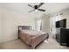 Well-lit bedroom featuring a ceiling fan and neutral decor at 11131 Cypress View Dr, Charlotte, NC 28262