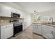 White kitchen with stainless steel appliances at 11131 Cypress View Dr, Charlotte, NC 28262