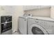 Bright laundry room with washer, dryer and water dispenser at 11131 Cypress View Dr, Charlotte, NC 28262