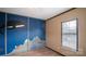 Bedroom with ocean mural, window with blinds, and wood floor at 202 Mountain View Dr, Taylorsville, NC 28681