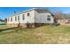 Side view of a single-story home with brick foundation and landscaped yard at 202 Mountain View Dr, Taylorsville, NC 28681