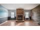 Living room with stone fireplace and wood-look flooring at 202 Mountain View Dr, Taylorsville, NC 28681