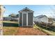 Gray storage shed with double doors, located on a grassy area at 202 Mountain View Dr, Taylorsville, NC 28681