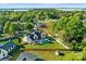 Stunning aerial view showcasing a modern home with a pool, a lush yard, and lake views at 20400 Rainbow Cir, Cornelius, NC 28031
