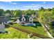 Aerial view of a lovely home with backyard pool, nestled among lush greenery and trees at 20400 Rainbow Cir, Cornelius, NC 28031