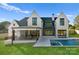 Stunning rear exterior showcases a luxurious pool and patio area, perfect for outdoor enjoyment at 20400 Rainbow Cir, Cornelius, NC 28031