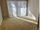 Cozy bedroom with carpet and sliding glass door providing plenty of light at 2518 Cranbrook Ln, Charlotte, NC 28207