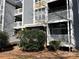 View of the condo building with multiple decks and a well-maintained landscape at 2518 Cranbrook Ln, Charlotte, NC 28207