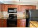 Well-equipped kitchen boasts granite counters, tile backsplash, and modern appliances at 2518 Cranbrook Ln, Charlotte, NC 28207