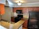 Well-equipped kitchen with wooden cabinets, granite countertops, and black appliances at 2518 Cranbrook Ln, Charlotte, NC 28207