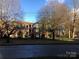 Brick apartment building with landscaping and street view at 325 Queens Rd # 15, Charlotte, NC 28204