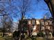 Brick building exterior with trees and clear sky in background at 325 Queens Rd # 15, Charlotte, NC 28204