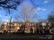 Brick apartment building with street view and large tree in front at 325 Queens Rd # 15, Charlotte, NC 28204