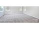 Well-lit bedroom with grey carpet and large windows at 3252 Mcharney Dr # 37, Harrisburg, NC 28075