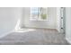 Bright bedroom with carpet flooring and large window at 3252 Mcharney Dr # 37, Harrisburg, NC 28075