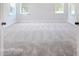 Bright bedroom featuring grey carpet and multiple windows at 3252 Mcharney Dr # 37, Harrisburg, NC 28075