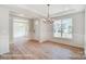 Bright dining room with hardwood floors and chandelier at 3252 Mcharney Dr # 37, Harrisburg, NC 28075