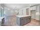 Gray kitchen island with white countertops and hardwood floors at 3252 Mcharney Dr # 37, Harrisburg, NC 28075