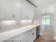 White kitchen cabinets and quartz countertops with wine cooler at 3252 Mcharney Dr # 37, Harrisburg, NC 28075