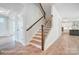 Elegant staircase with wooden steps and iron railings at 3252 Mcharney Dr # 37, Harrisburg, NC 28075