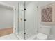 Elegant bathroom with glass enclosed shower with decorative tile floor, modern fixtures, and clean design at 4026 Chevington Rd # 102, Charlotte, NC 28226