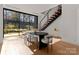 Dining room featuring an oval table, modern chairs, hardwood floors, and a view of the backyard at 4026 Chevington Rd # 102, Charlotte, NC 28226