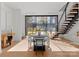 Bright dining area with an oval table, chairs, hardwood floors, and a wall of windows to the backyard at 4026 Chevington Rd # 102, Charlotte, NC 28226