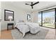 Light filled main bedroom featuring a comfy bed, a ceiling fan, and large windows offering natural light at 4026 Chevington Rd # 102, Charlotte, NC 28226