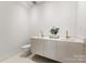 Modern bathroom with double vanity sinks with gold fixtures at 4026 Chevington Rd # 103, Charlotte, NC 28226