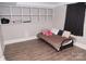 Basement bedroom with built-in shelving and a daybed at 5824 Crossing King Dr, Charlotte, NC 28212