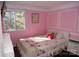 Charming bedroom with floral bedding and pink walls at 5824 Crossing King Dr, Charlotte, NC 28212