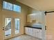 Kitchen features white cabinets, patio access and barn door at 6130 Heathstone Ln, Charlotte, NC 28210