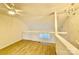 Spacious loft area with hardwood floors and ceiling fan at 6130 Heathstone Ln, Charlotte, NC 28210