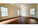 Bedroom with hardwood floors and multiple windows at 1001 Jessica Ln, Matthews, NC 28104