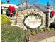 Stone entrance sign for Curry Place, decorated with wreaths at 1001 Jessica Ln, Matthews, NC 28104