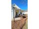 House exterior with a covered porch, brick columns, and neatly trimmed landscaping at 1001 Jessica Ln, Matthews, NC 28104