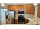 Modern kitchen with stainless steel appliances and wood cabinets at 1001 Jessica Ln, Matthews, NC 28104