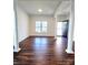 Bright living room with hardwood floors, columns, and neutral paint at 1001 Jessica Ln, Matthews, NC 28104