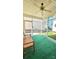 Relaxing screened porch with ceiling fan and artificial turf flooring at 1001 Jessica Ln, Matthews, NC 28104