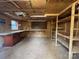 Unfinished basement with wood walls and ceiling, built-in shelving, and a workbench along the back wall at 110 Yorktowne St, Fort Mill, SC 29715