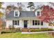 Inviting home exterior showcasing a cozy front porch with black door, brick steps, and manicured landscaping at 110 Yorktowne St, Fort Mill, SC 29715