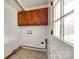 A simple laundry room features upper cabinets and a door leading to the outside at 110 Yorktowne St, Fort Mill, SC 29715