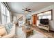 Inviting living room featuring a comfortable sofa, wood-look floors, and a view to the staircase at 110 Yorktowne St, Fort Mill, SC 29715