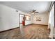 Spacious living room featuring wood-look floors, neutral walls, ceiling fan, and view into adjacent kitchen at 110 Yorktowne St, Fort Mill, SC 29715