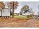 Exterior view of a home with multiple storage buildings, set on a natural lot with mature trees at 110 Yorktowne St, Fort Mill, SC 29715