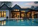 Captivating twilight view of the home's backyard featuring a sleek pool and beautifully illuminated outdoor spaces at 116 Hunt Camp Trl # 11, Davidson, NC 28036